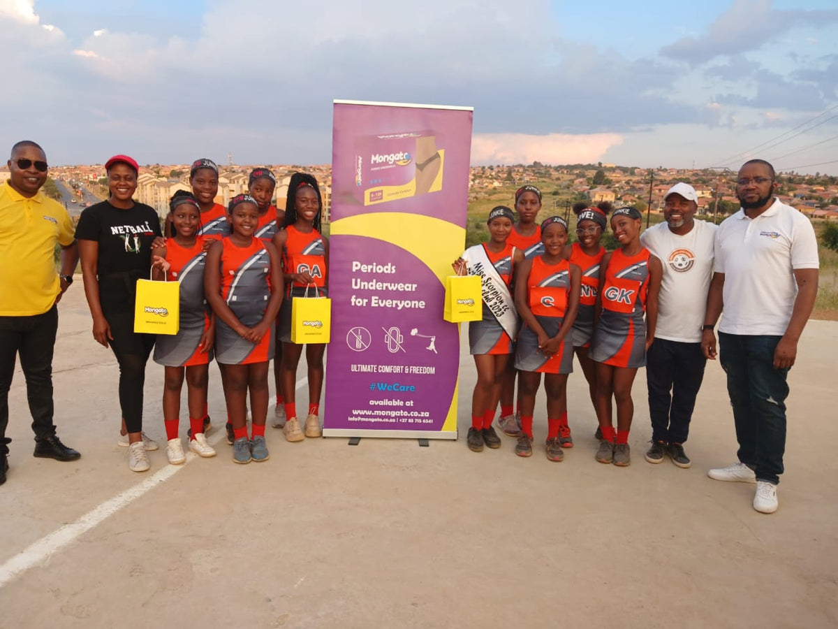 A girls netball team with the Mongato team at a community event