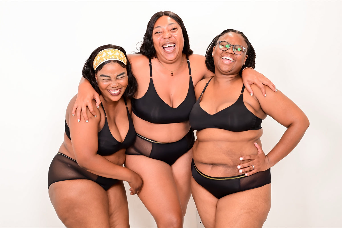 Three women laughing together in Mongato period underwear